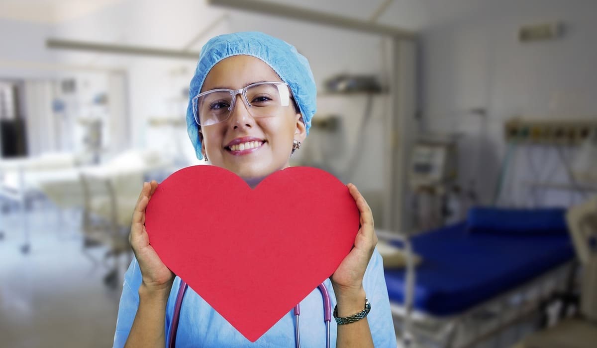 a nurse holding heart symbol