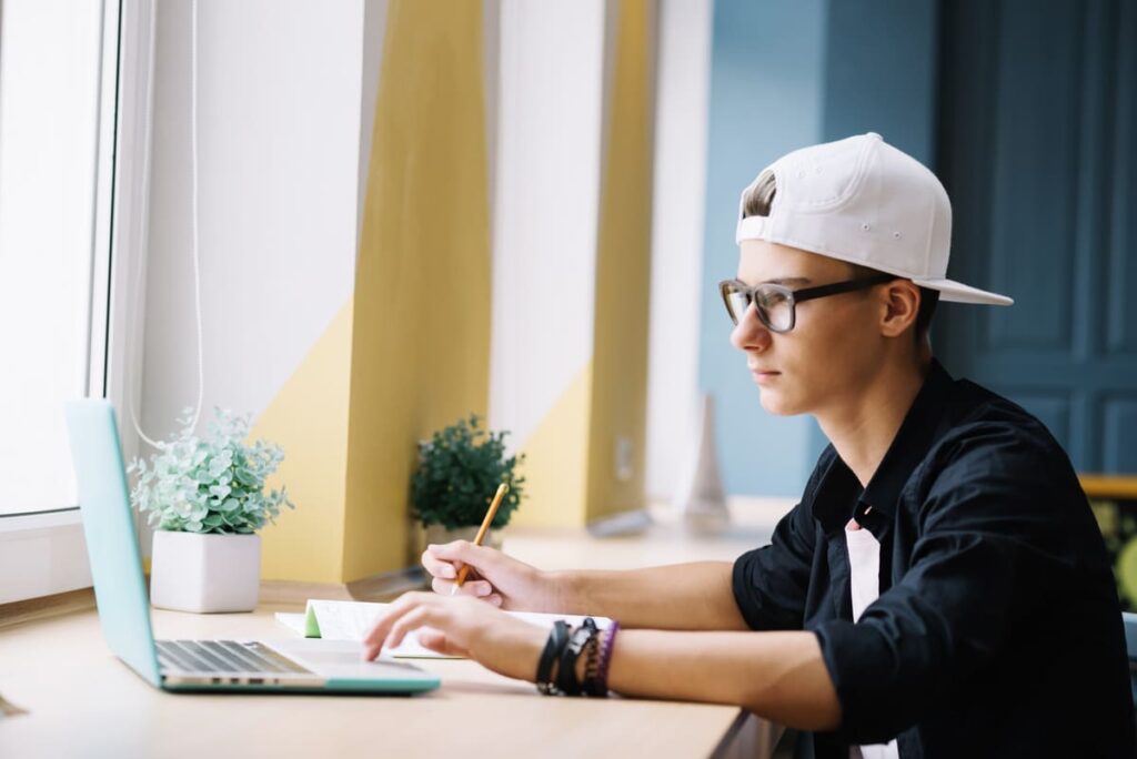 a young boy working on laptop