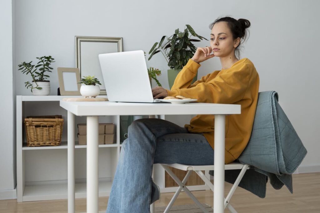 a young girl working on laptop